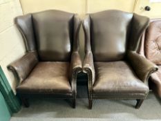 A pair of brown button leather 20th century armchairs