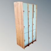 A set of nine pine framed lockers (no keys) CONDITION REPORT: one open rest are