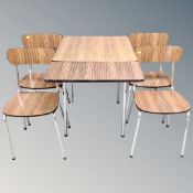 A 20th century tubular steel and veneered drop leaf table and four chairs by Tavor of Belgium