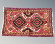 A Baluchi rug 188cm by 77cm