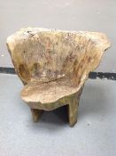 A rustic tree stump seat