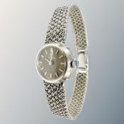 A lady's 9ct white gold Omega manual-wind wristwatch on 9ct gold integral bracelet, case 22mm.