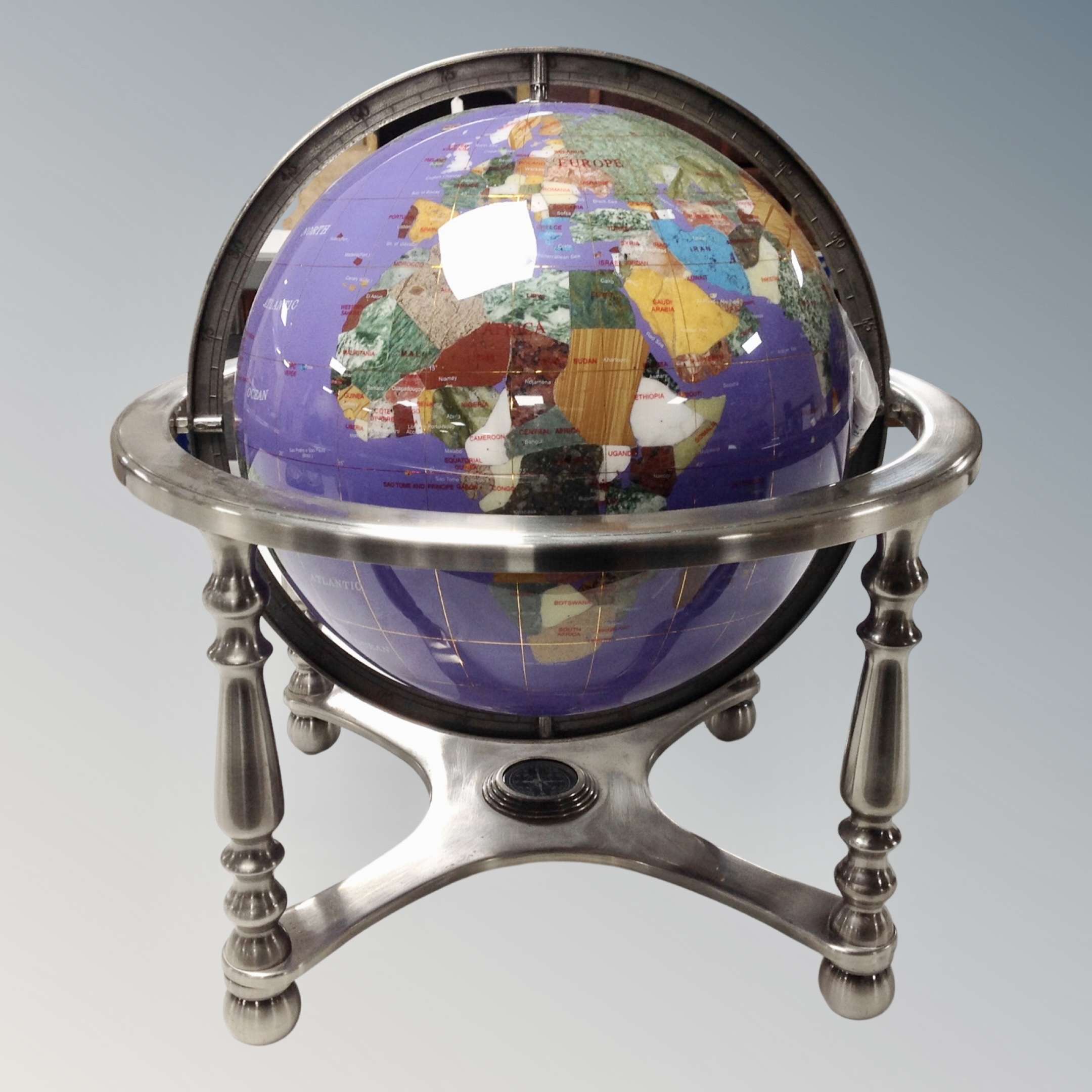 A gemstone globe with certificate.