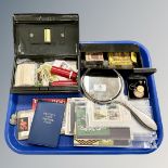 A tray containing silver hand mirror, silver ARP badge, tin of coins, silver ring, cigarette cards,