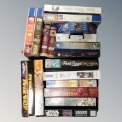 Two boxes containing a large quantity of jigsaws and board games relating to Harry Potter,