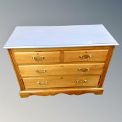An antique style four drawer chest with painted top