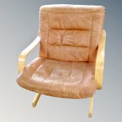 A tan leather and beech frame relaxer chair