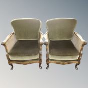 A pair of beech bergere armchairs with green cushions
