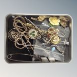 A small tin of silver and silver gilt earrings, leopard pendant on chain, lapel and stick pins,