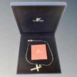 A Swarovski crystal cross pendant on chain.