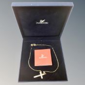 A Swarovski crystal cross pendant on chain.