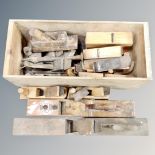 A crate containing vintage wooden woodworking planes.