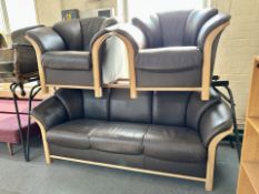 A three piece brown leather and light oak framed lounge suite