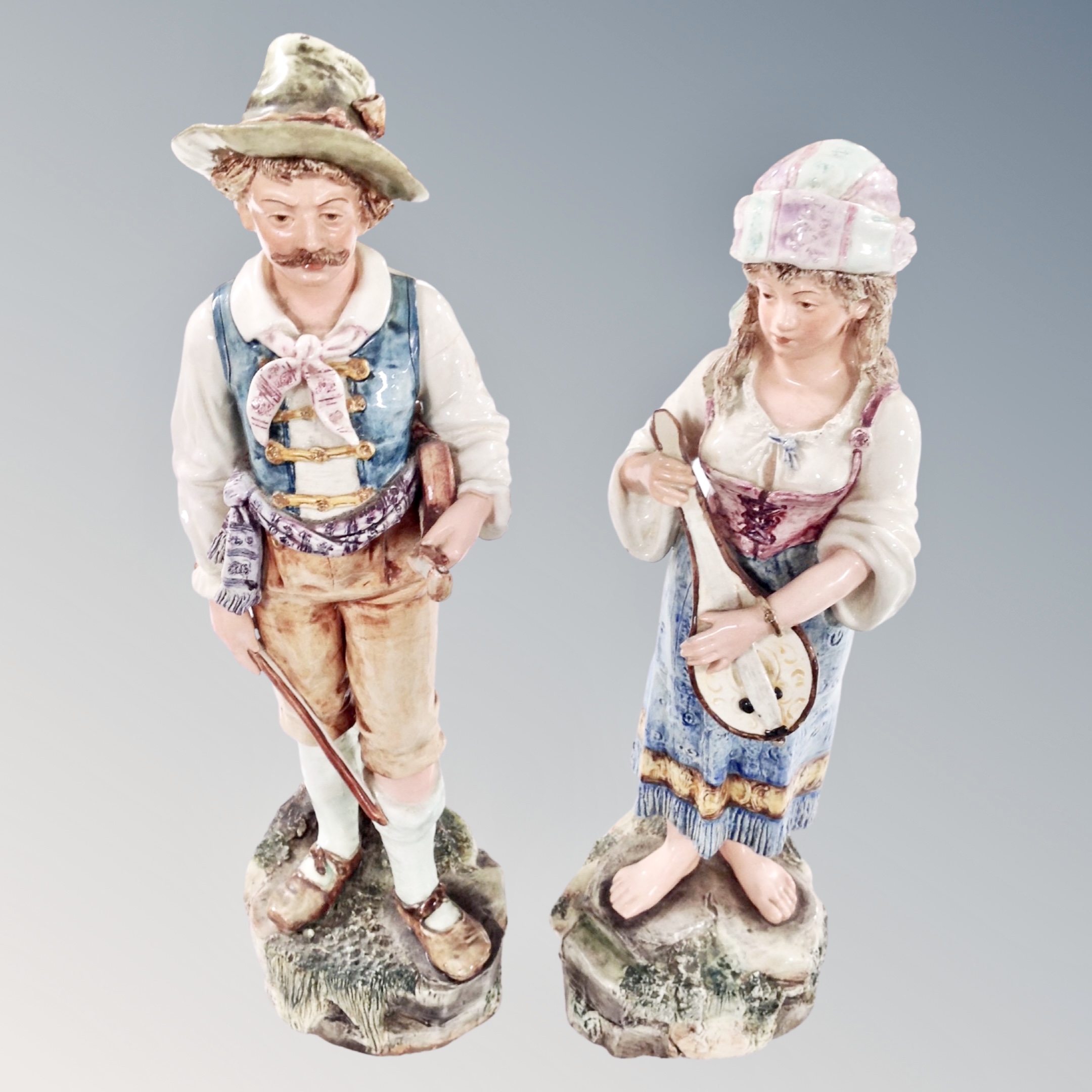 A pair of 19th century continental figures of travelling musicians.