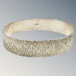 A textured silver bangle, diameter 6cm. CONDITION REPORT: 27.