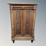 A continental oak double door corner cabinet