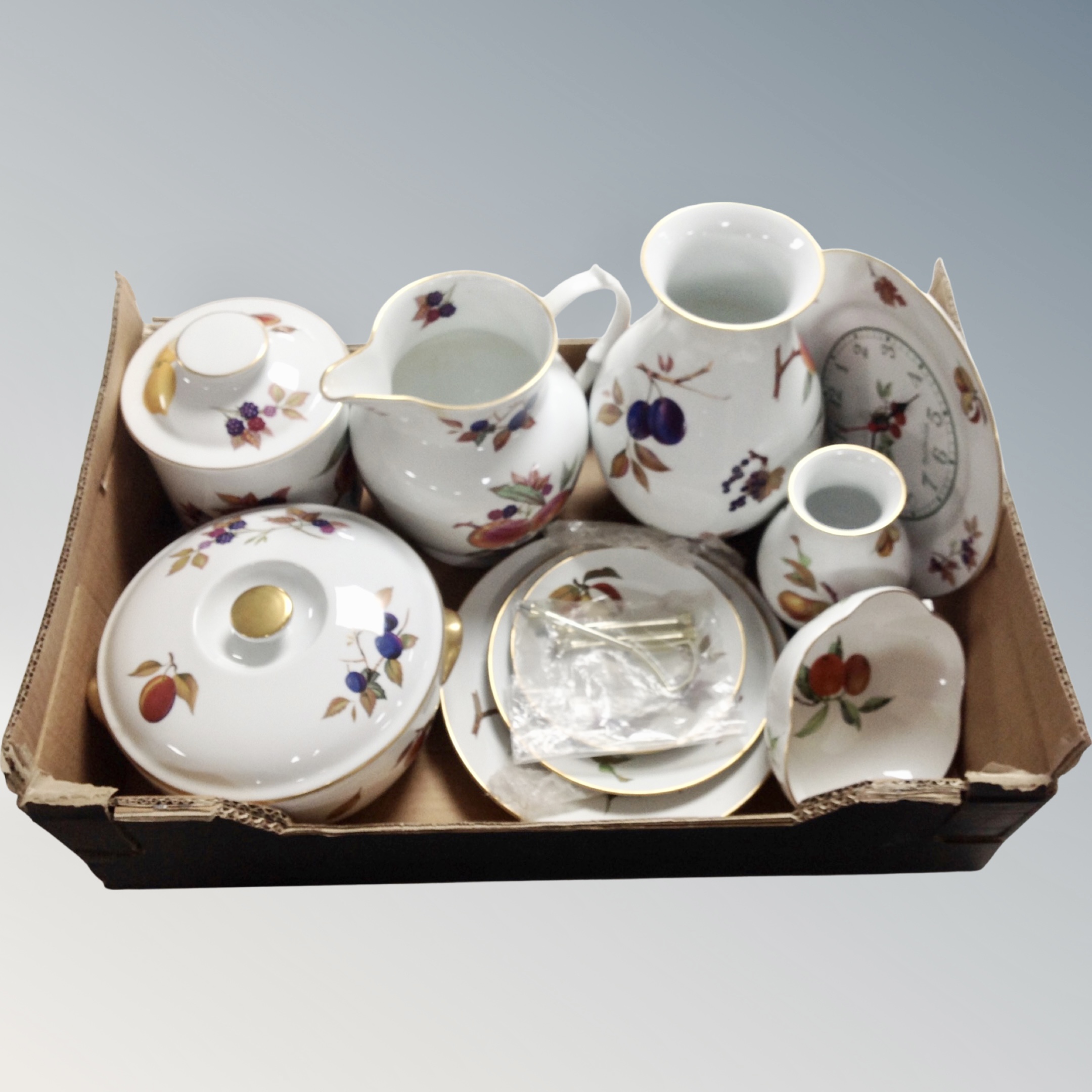 A box containing eight pieces of Royal Worcester Evesham to include vases, cake stand, wall clock,