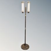 A contemporary metal and glass floor light