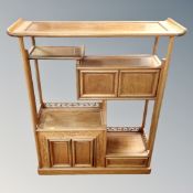 An oriental style hardwood multi tier stand