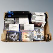 A box containing a Sony Playstation 2 together with a quantity of games.