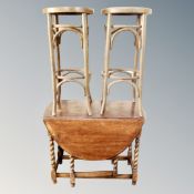 An oak gate leg table and a pair of Bentwood bar stools