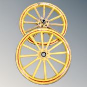 A pair of antique wooden cart wheels