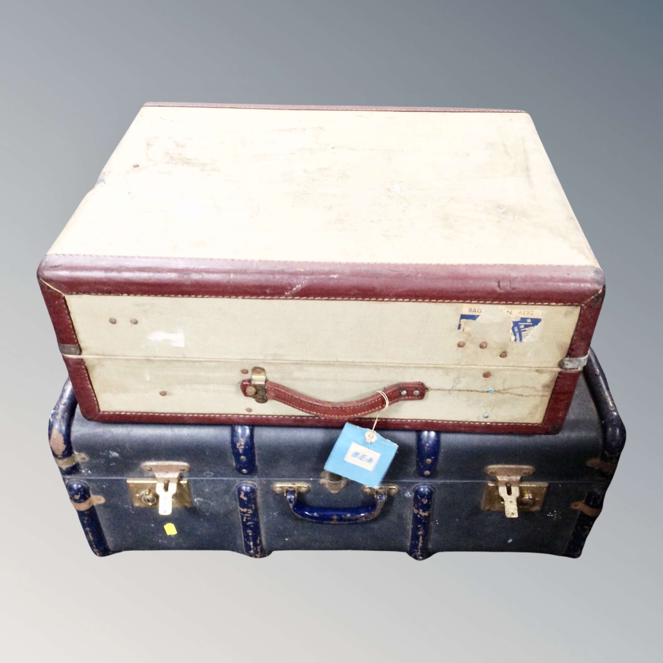 A vintage wooden bound travelling trunk together with a further vintage suitcase.