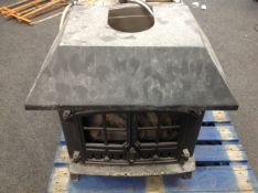 A cast iron gas fire in the form of a log burner.