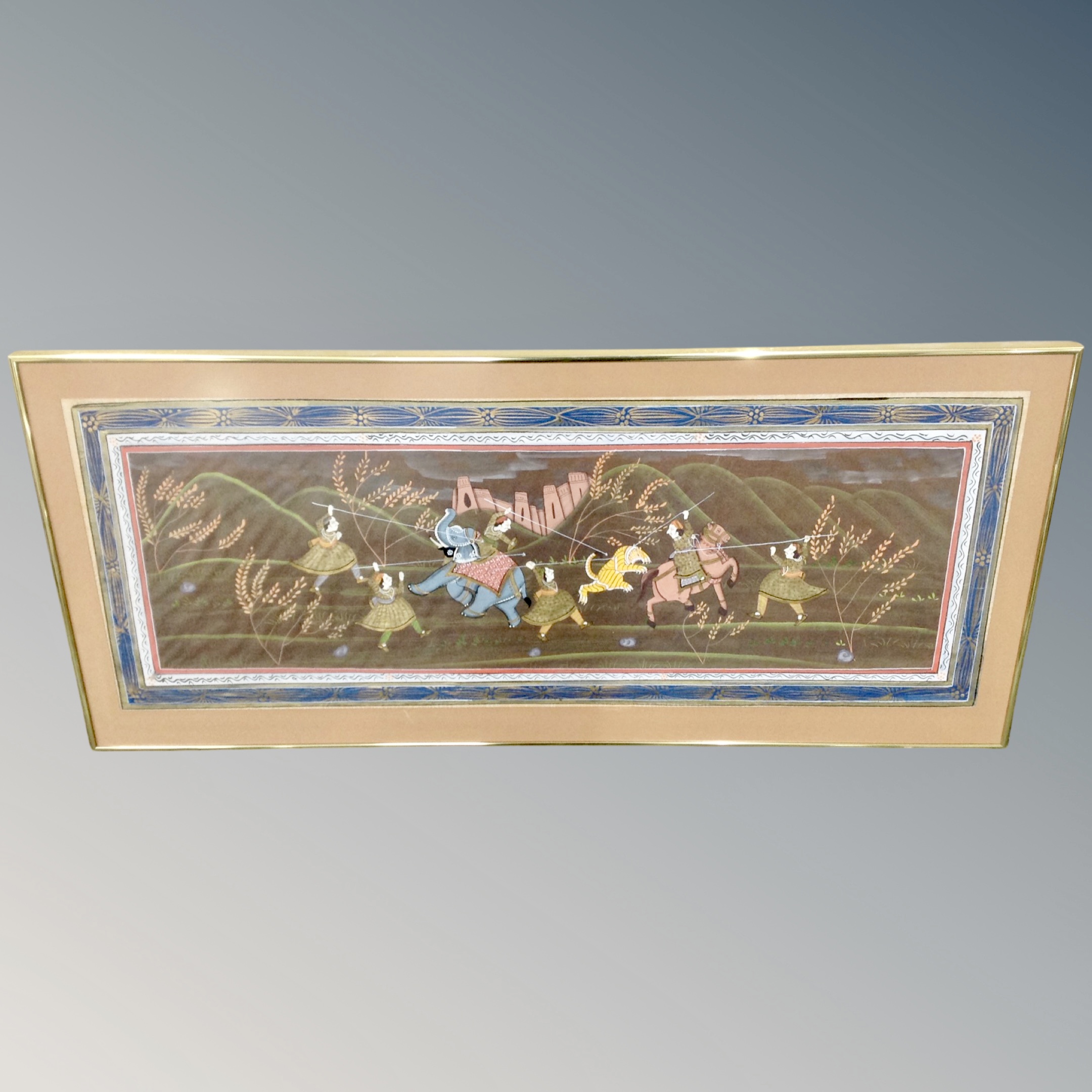 An Indian watercolour depicting a tiger hunt in frame and mount.