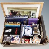 A box containing Star Wars and Harry Potter ephemera to include framed pictures, books, boxed mugs,