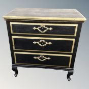 A continental black and gilded three drawer chest