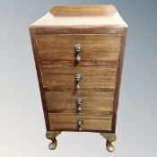 A 20th century stained beech four drawer bedside chest