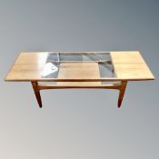 A mid century teak low table with glass top