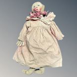 A 19th Century rag doll, clothed in a dress, under garments and gloves, height 76 cm.