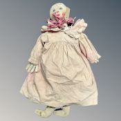 A 19th Century rag doll, clothed in a dress, under garments and gloves, height 76 cm.