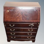 A reproduction mahogany bureau