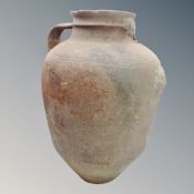 An antique pottery urn with handle (af). Height 50 cm.