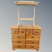 A contemporary pine ten drawer chest together with a further pine writing desk