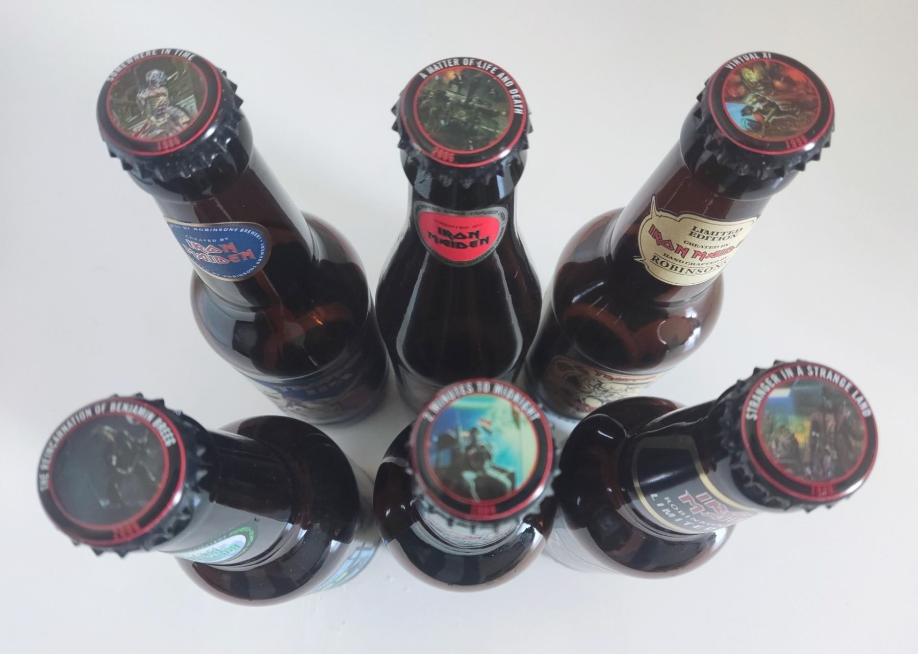 Iron Maiden Trooper beer bottles and six bottle caps. - Image 2 of 2