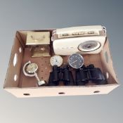 A box containing assorted desk clocks, field glasses, Bush radio.