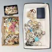 A shoe box containing costume jewellery, brooches, bracelets,