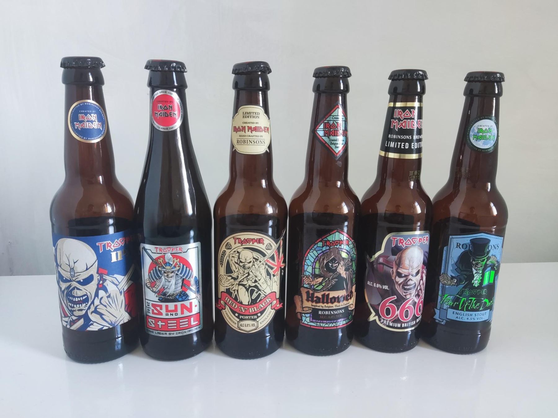 Iron Maiden Trooper beer bottles and six bottle caps.