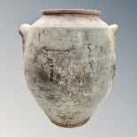 An antique pottery storage jar, height 38cm.