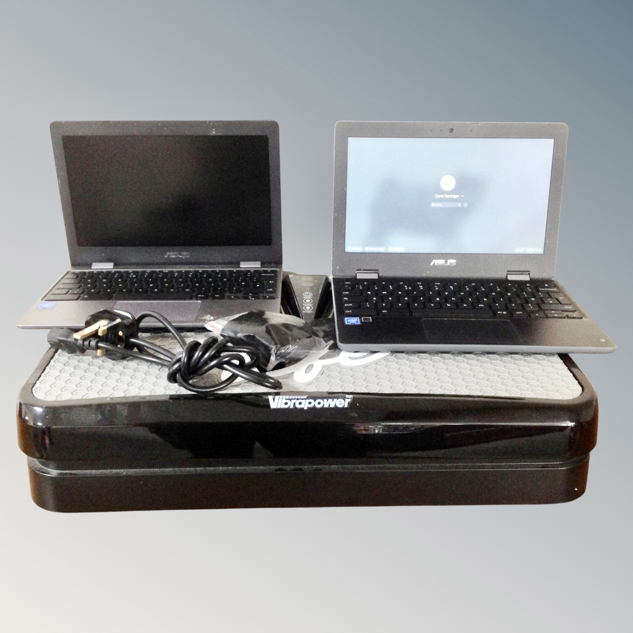 A vibra power vibration plate together with two Asus chrome books (no leads).