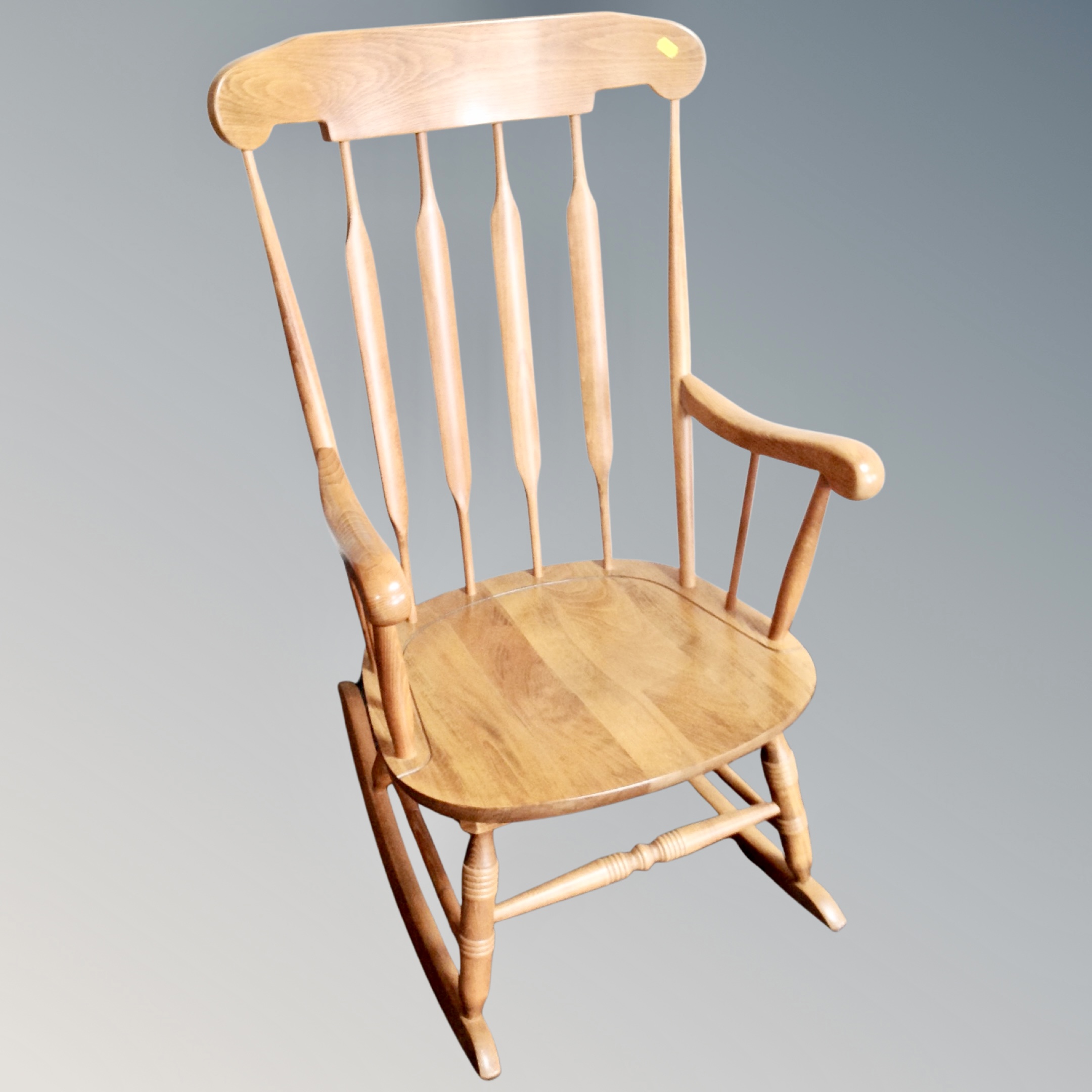 A beech spindle backed rocking chair