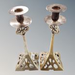 A pair of Arts and Crafts plated candlesticks