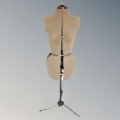 An adjustable dress maker's form on stand