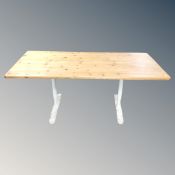A pine topped refectory kitchen table on metal legs