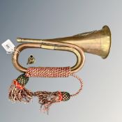 A copper and brass bugle with facsimile Argyll and Sutherland Highlanders badge