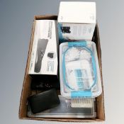 A box containing revamp professional hair curler, a innovo pelvic floor exerciser, steamer,